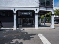 a small business in a city on the street corner with signs on it that read,'heritage henge '