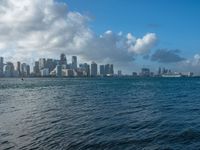 the view from across the water of the city skyline and harbor boats in the water