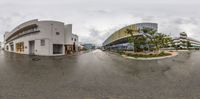 360 - view image of the corner of a city street with buildings and a bus stop