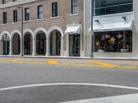 a parking meter and yellow traffic circle on the corner of an urban street in a city