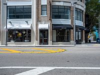 a parking meter and yellow traffic circle on the corner of an urban street in a city