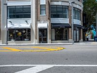 a parking meter and yellow traffic circle on the corner of an urban street in a city