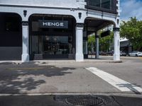 a small business in a city on the street corner with signs on it that read,'heritage henge '