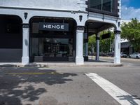 a small business in a city on the street corner with signs on it that read,'heritage henge '