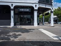 a small business in a city on the street corner with signs on it that read,'heritage henge '