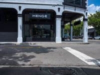 a small business in a city on the street corner with signs on it that read,'heritage henge '