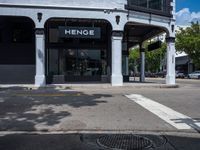 a small business in a city on the street corner with signs on it that read,'heritage henge '