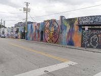 a row of buildings that have been painted on the side of them by graffitiists