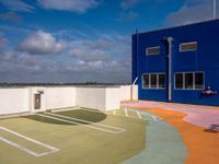 this is an image of the empty tennis court outside of a building in florida city