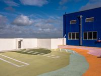 this is an image of the empty tennis court outside of a building in florida city