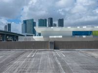 an empty car park and parking lot in front of the skyline in miami, fl