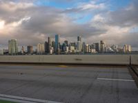 a view of the city from the freeway under cloudy skies in a scenic setting in chicago