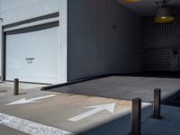 a gray walkway leading up to a building next to a yellow light lantern on top