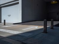 a gray walkway leading up to a building next to a yellow light lantern on top