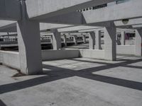 large, cement - lined parking garage with elevated platforms, underpass, and elevated concrete platform