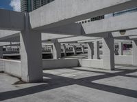 large, cement - lined parking garage with elevated platforms, underpass, and elevated concrete platform