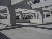 large, cement - lined parking garage with elevated platforms, underpass, and elevated concrete platform