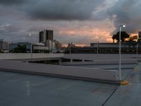 a sky view with a cloudy horizon and a lot of buildings in the background at dusk