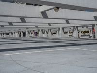 a parking lot with multiple levels in the background, and people walking past them on either side of it