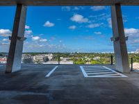 an empty parking space with the sky in the background and a view from inside the building