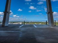 an empty parking space with the sky in the background and a view from inside the building