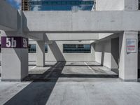 a empty parking garage with no vehicles under it's roofs and signs on the front doors