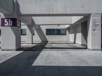 a empty parking garage with no vehicles under it's roofs and signs on the front doors