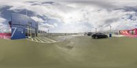 an empty parking lot with many cars outside it at a carnival park and convention center