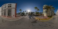 a wide angle of some buildings and cars on the street together in this 360 - lens view