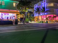 the ocean drive in south beach is lit up with purple and green lights as part of a new year's eve celebration