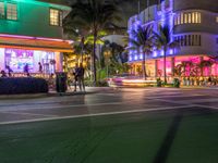 the ocean drive in south beach is lit up with purple and green lights as part of a new year's eve celebration