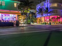 the ocean drive in south beach is lit up with purple and green lights as part of a new year's eve celebration