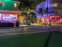 the ocean drive in south beach is lit up with purple and green lights as part of a new year's eve celebration