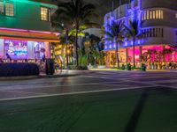 the ocean drive in south beach is lit up with purple and green lights as part of a new year's eve celebration