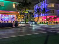 the ocean drive in south beach is lit up with purple and green lights as part of a new year's eve celebration