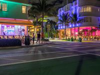 the ocean drive in south beach is lit up with purple and green lights as part of a new year's eve celebration