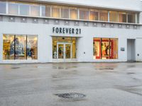 a photo of a store front with a fire hydrant on the street corner in front of it