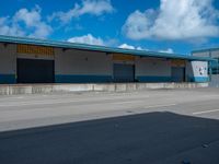 an empty lot with an empty parking lot in the background and clouds in the distance