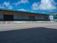 an empty lot with an empty parking lot in the background and clouds in the distance