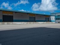 an empty lot with an empty parking lot in the background and clouds in the distance