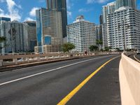 a street view of skyscrapers on a bright sunny day with a blue sky above