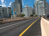 a street view of skyscrapers on a bright sunny day with a blue sky above