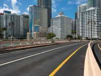 a street view of skyscrapers on a bright sunny day with a blue sky above