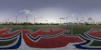 a field with some painted letters in it and palm trees in the background with the word love on the field