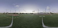 an artistic view of a school football field during sunset with markings on the turf and the numbers on the field are painted