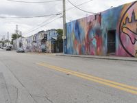 the colorful walls are next to the road on a sunny day in a city with no cars