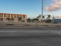 there is a person riding a motorcycle on the road at dusk in the city of miami