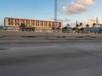 there is a person riding a motorcycle on the road at dusk in the city of miami