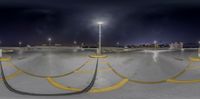 a panoramic photo of an empty parking lot at night and full of traffic