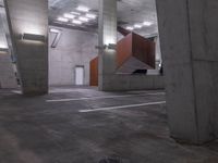 a parking lot with concrete pillars and ceiling lights in a warehouse building with orange doors